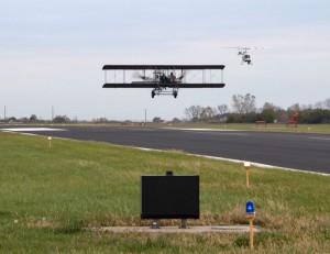 Wright "B" Flyer look-a-like takes off with trailing helicopter
