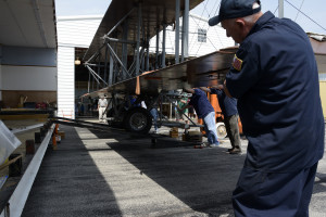 Photo of volunteers loading the Wright "B" Flyer into its custom trailer for shipment to EAA AirVenture 2015 in Oshkosh, Wis.