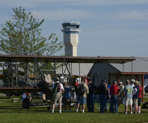 Photo of Wright "B" Flyer on display with Wittman Field tower in background.